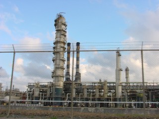 Outside fence photo of refinery.