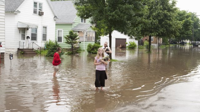 A family outside in a flood.