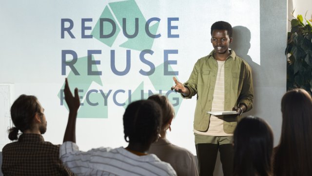 Student giving presentation about reduce, reuse, recycle 