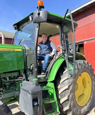 EPA Regional Administrator Mike Martucci sitting in a John Deere Tractor.