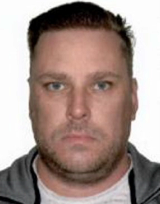 headshot of white male with brown short hair, blue eyes and shadow facial hair