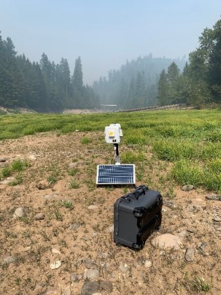 WSMART solar powered sensor system setup near the fire to monitor PM2.5 and carbon monoxide. Photo by  Amara Holder. 