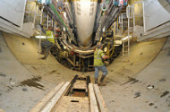 man inside a large water culvert