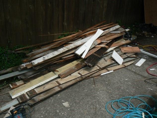 EPA photo shows Hammer & Hand failed to contain waste from renovation activities to prevent releases of dust and debris before the waste is removed from the work area for storage or disposal as shown in this pile of unwrapped construction debris.