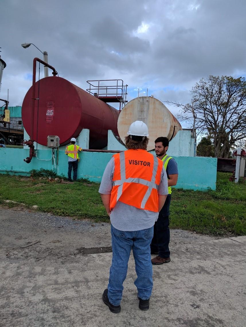 Workers inspect tanks at a wastewater treatment plant.