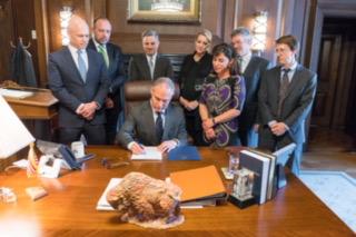 Pruitt sitting at a table surrounded by others.
