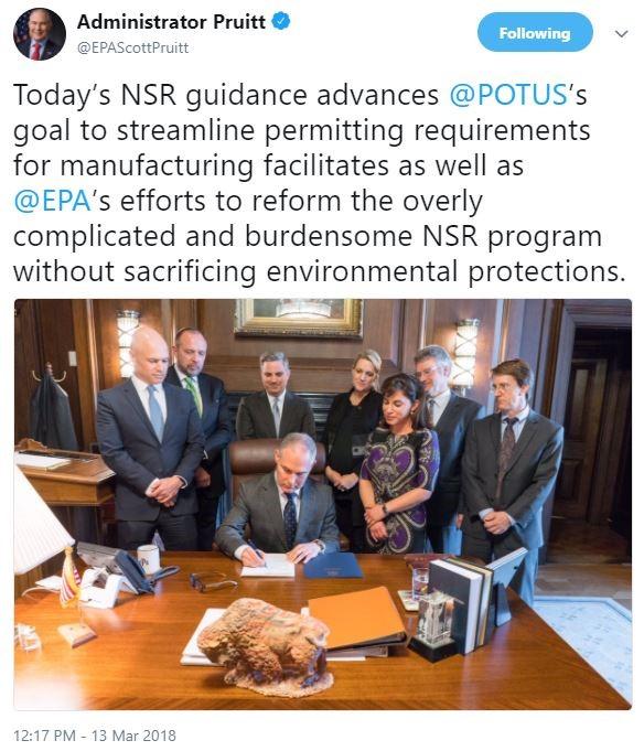tweet of signing photo Man in gray suit and blue tie (Administrator Pruitt) seated at large wood desk signing document. seven people standing around the back of chair watching signing
