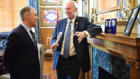 Administrator Pruitt speaking with Gov. Asa Hutchinson, standing near an ornate fireplace