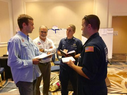 EPA Planning Section Chief Matt Huyser (left) and EPA Unified Commander Ben Franco (center) brief U.S. Coast Guard members on EPA activities at the Unified Command in Miami. 