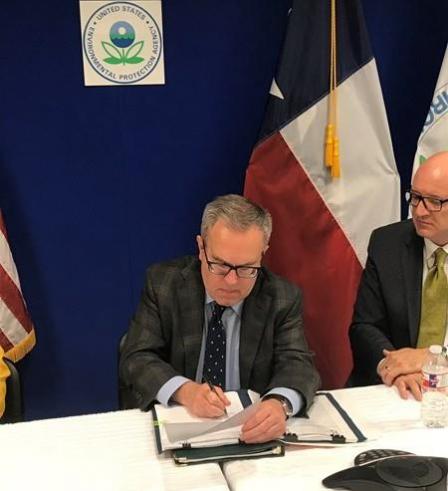 Wheeler signing piece of paper/rule.