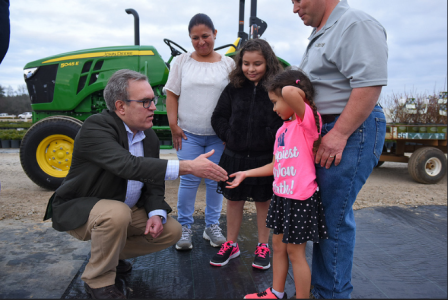 Wheeler greeting young kids.