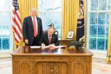 photo of President Trump watching Administrator Pruitt signing papers