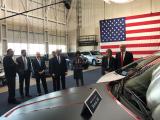 photo of President Trump, EPA Administrator Scott Pruitt, DOT Secretary Mrs. Chao, GM CEO Mary Berra, and others looking at a car marked Proudly made in Detroit MI