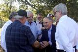 EPA Administrator Scott Pruitt and Mississippi Governor Phil Bryant stand under trees greeting stakeholders at Gaddis Farms