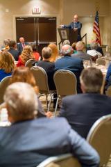Scott Pruitt stands at a lectern addressing tables full of members of the Georgia Farm Bureau