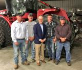 Administrator Pruitt and four men stand in front of a large tractor