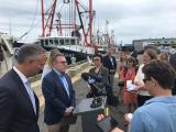 Acting Administrator Wheeler stands at a podium with microphones while reporters and others look on