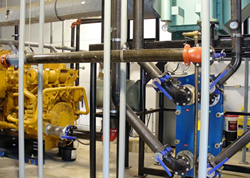 Heat exchanger that works in conjunction with an engine-generator set to recover heat for space and water heating, thus reducing fuel oil or propane costs.
