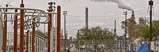 Decorative photograph showing a playground and industrial activity
