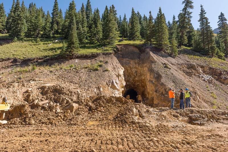 side of a hill with a large opening and lots of excavation