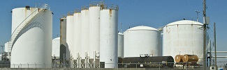 Picture of a series of large white silos and tanks adjacent to each other