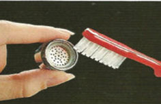 Photo showing how to clean aerator with toothbrush