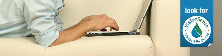 Man using a laptop on couch.
