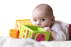Baby sucking on plastic toys
