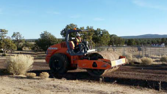 Steamroller working on a road.