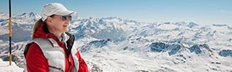 person surrounded by snow-covered mountains