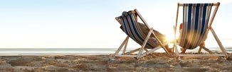 two beach chairs on sand