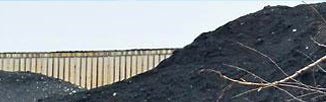 Petroleum coke pile in a sunny Chicago setting