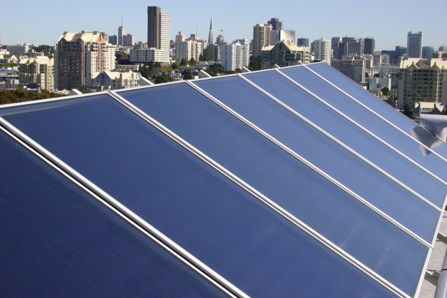 Photo: flat-plate array on the roof of an apartment building