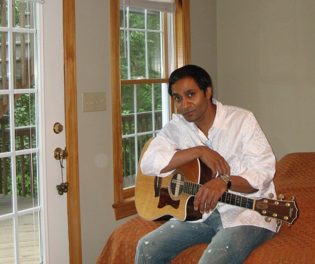 Vasu Kilaru at home with his guitar