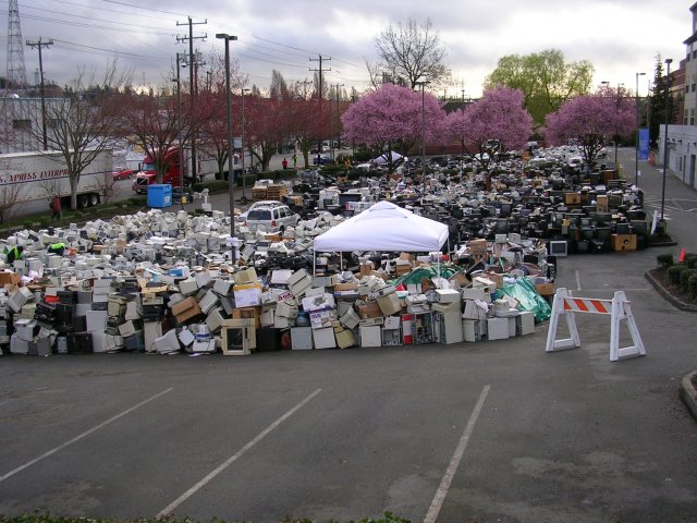 This image is of a parking lot filled with electronics--especially monitors with cathode ray tube that were collected for recycling in 2008. Thousands of electronics are shown in the photograph.