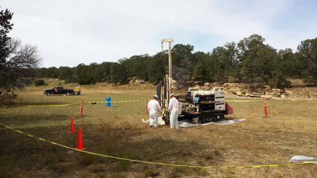 Workers in field with coring equipment