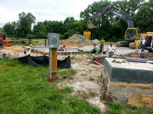 Workers help ready new sewer system.