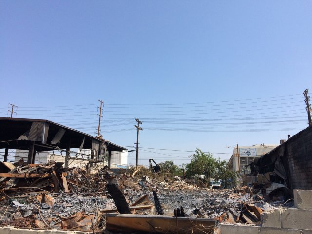 Another view of a fire gutted building and debris