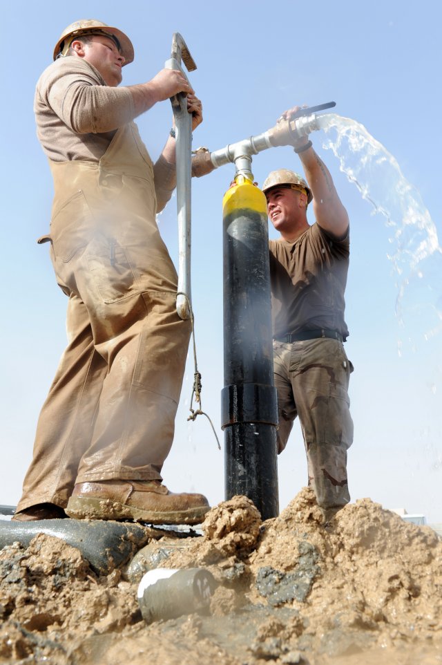 two professionals cap an artesian well