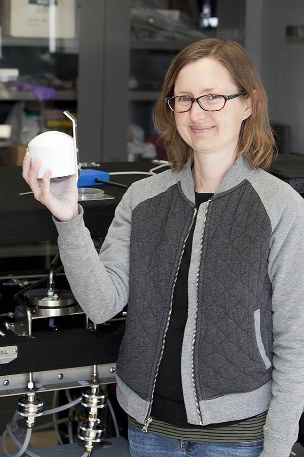 EPA scientist Amara Holder holds up the sensor.