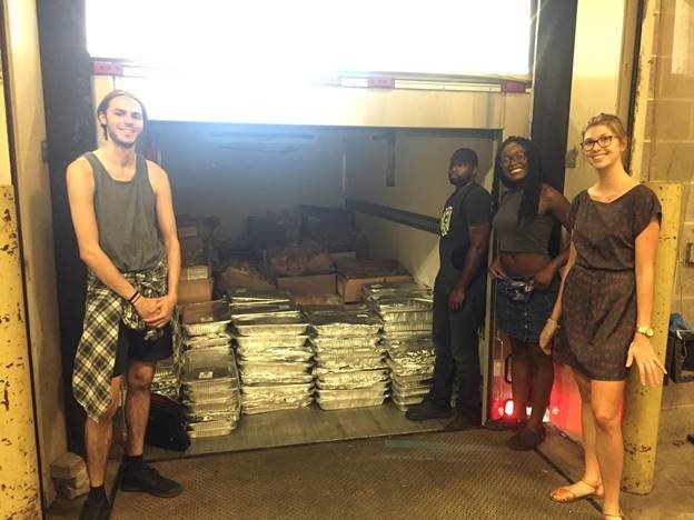 This is a picture of student loading a truck of food donations.