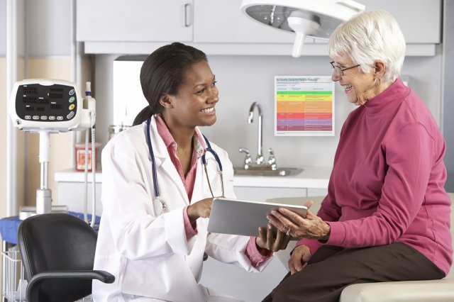 Doctor counseling patient in doctor's office setting