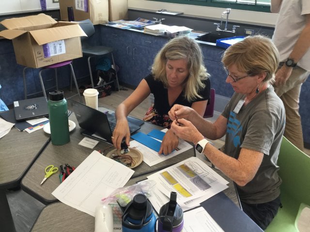 At a workshop in Waimea, Hawaii, high school teachers Heather O’Connell (left) and Una Burns (right) learn how to assemble the particle sensors with the MIT team’s instructions.