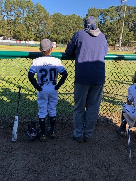 Dr. Ryan, with his son, in his favorite thinking spot: reflecting, teaching, and learning together.