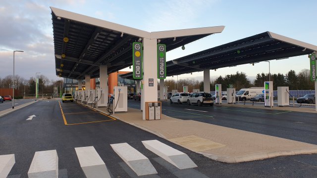 EV Charging Station that looks similar to a gas station with spots for ~20 vehicles