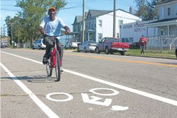 man riding a bike in a bike lane