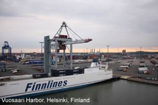 A photograph of a container vessel and gantry crane and container yard in Vuosaari Harbor, Helsinki, Finland.