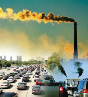 A photograph of highway traffic in a city with black smoke being emitted from truck and smoke stack.