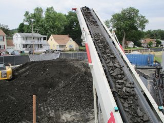 Filter Cake on Conveyor Being Transferred onto Staging Area for Subsequent Off-site Disposal – June 2017