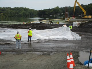 Covering Pile of Dredged/Processed Sediment in Staging Area – September 2016